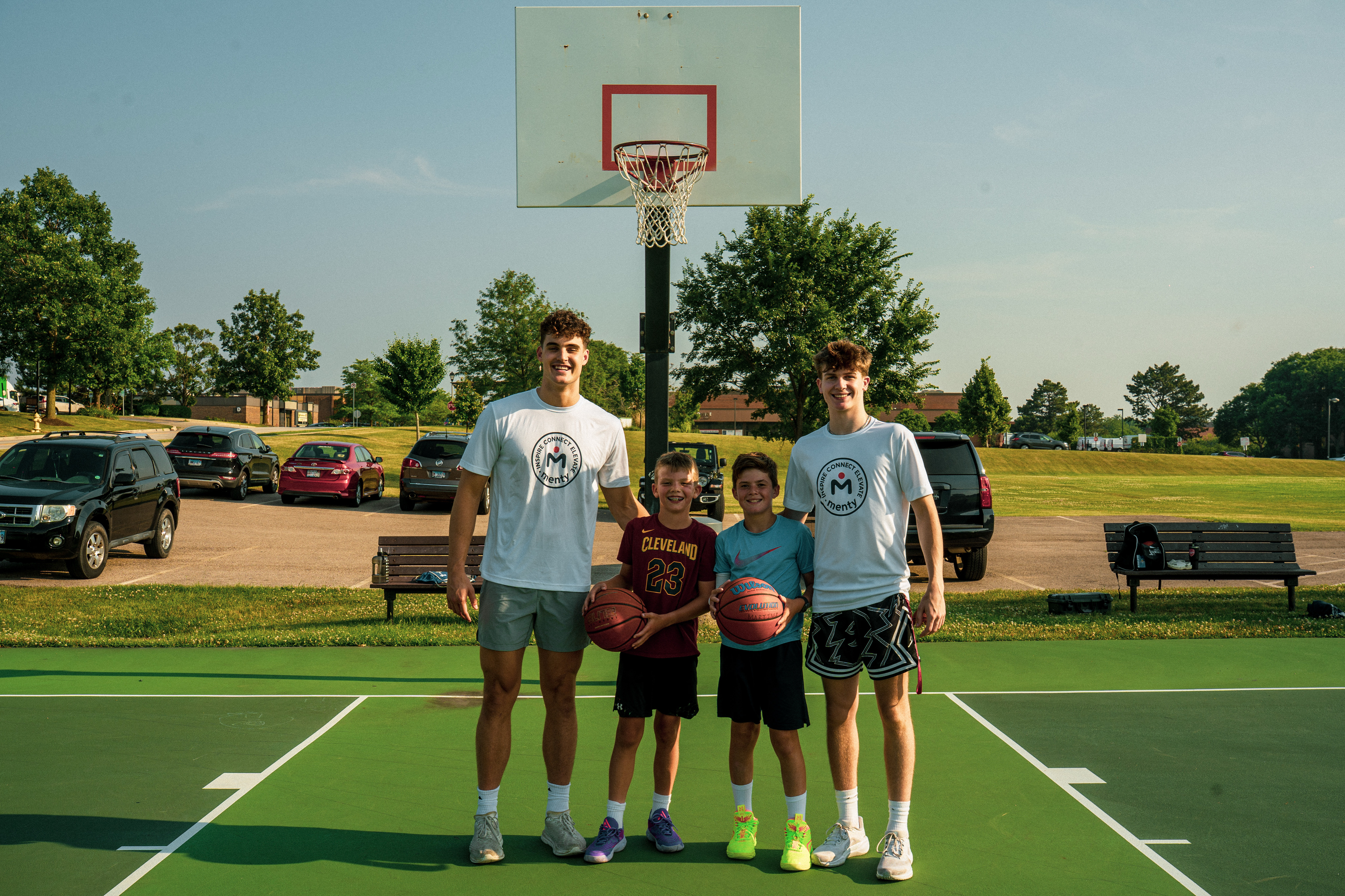 Mentors and young athletes on the court in Menty jerseys