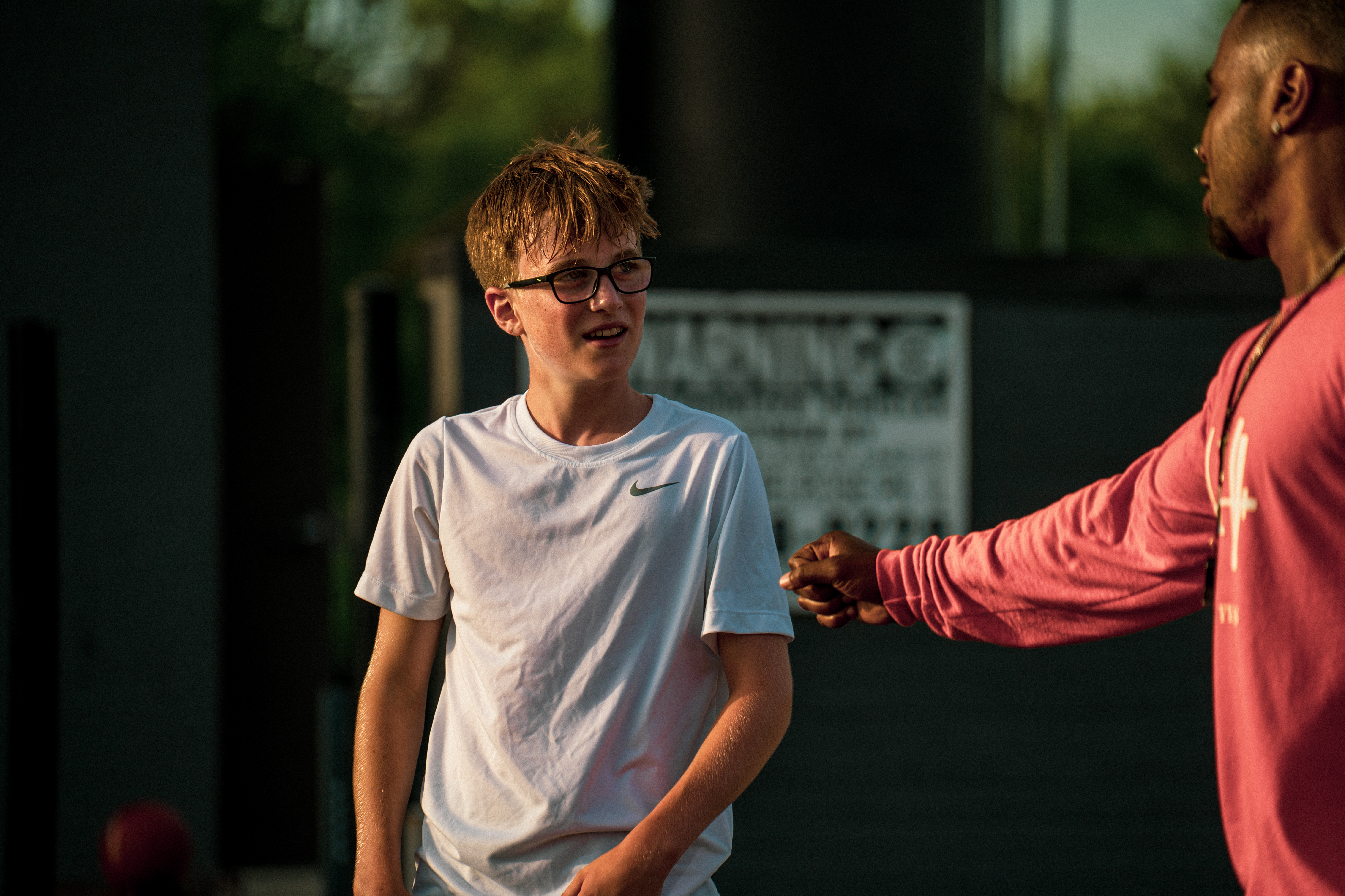 Mentor and athlete fistbump after a session